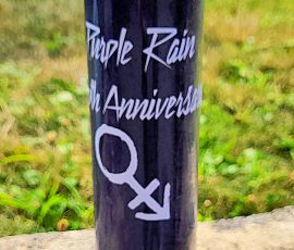 A table set for legends — celebrating 40 years of Purple Rain, Prince style. Purple Rain-themed candle, record, and flowers centerpiece on a purple table